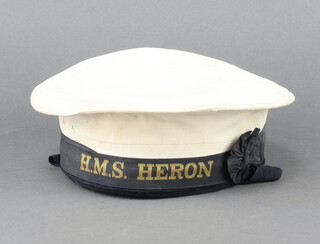 A Royal Naval ratings cap with title HMS Heron 
