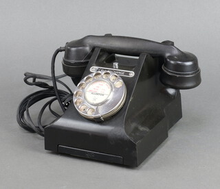 A black Bakelite dial telephone, base marked GPO 4550 