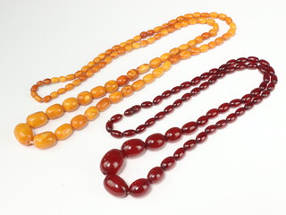 A red amberoid graduated bead necklace 88cm, a yellow ditto 104cm 