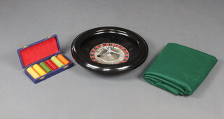 Chad Valley, a circular black plastic roulette wheel 7cm x 39cm together with  approx. 134 counters and a green baize cloth 