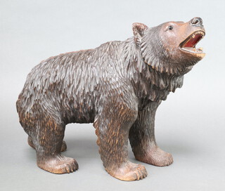 A good Bavarian carved wooden figure of a standing brown bear with open mouth and glass eyes 13cm h x 41cm l x 14cm w