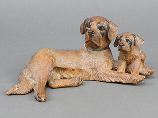 A Black Forest style carved wooden figure of a seated dog and puppy 9cm 