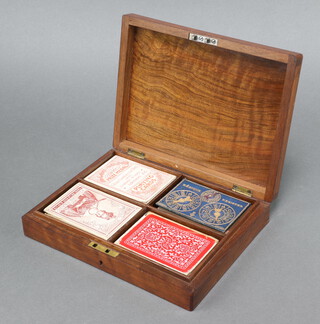 A 19th Century mahogany card box with hinged lid containing playing cards - National Playing Cards no.75 (complete), J H Harrison (the king and 8 of clubs, queen of diamonds and ace of spades have cut corners), Thomas De La Rue Royal Victoria playing cards (8 of spades missing) Chas. Goodall & Sons (ace of spades has cut corner)   