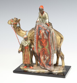 After Bergman, a cold painted spelter table lighter in the form of a rug vendor with camel, raised on a rectangular glass base 19cm h x 14.5cm w x 8cm d 