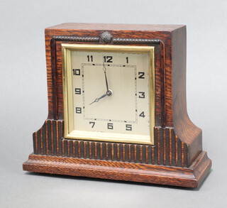 An Art Deco timepiece with 11cm square silvered dial, Roman numerals, contained in an oak case 21cm h x 24cm w x 8cm d  