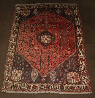 A red, blue and white ground Afghan rug with central medallion 292cm x 210cm, some wear and flecking in places 