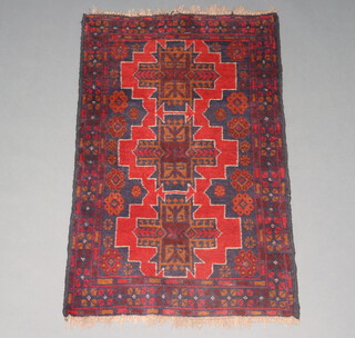 A black and red ground Afghan rug with 3 diamonds to the centre 123cm x 84cm 