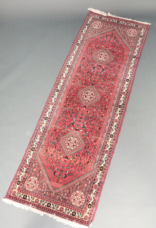 A pink, blue and white ground Persian runner with 3 diamonds to the centre 290cm x 92cm  