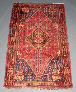 A red, blue, orange and black ground Afghan rug with central medallion within a multi row border 255cm x 163cm  