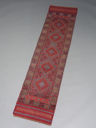 A blue and red ground Meshwani runner with 5 diamonds to the centre 244cm x 59cm 