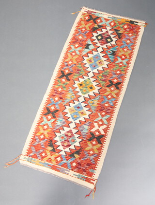 A white, turquoise and orange ground Chobi Kilim runner with all over geometric design 148cm x 60cm 