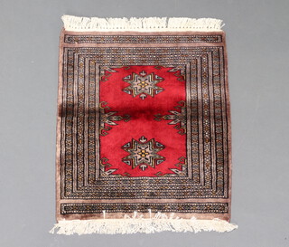 A red and green ground Mori Jaldar slip rug 55cm x 47cm 