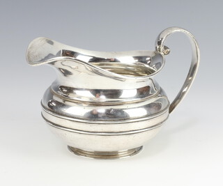A silver baluster milk jug with strap work decoration Sheffield 1926, 240 grams