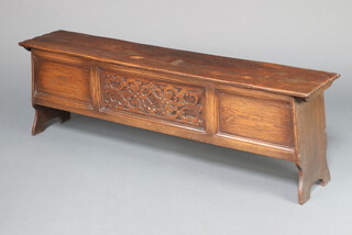 A 1930's 17th Century style oak coffer of panelled construction with hinged lid 49cm h x 152cm w x 31cm d 