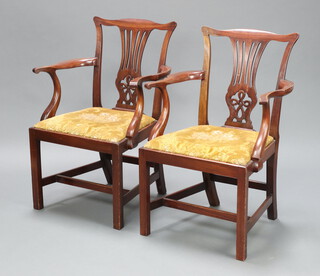 A pair of Edwardian Chippendale style open arm chairs with vase shaped slat backs and upholstered drop in seats raised on square supports with H framed stretchers 96cm h x 64cm w x 50cm d 