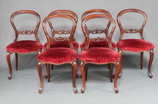 A set of 6 Victorian spoon back dining chairs with carved mid rails, overstuffed seats of serpentine outline, raised on cabriole supports 89cm h x 50cm w x 41cm d 