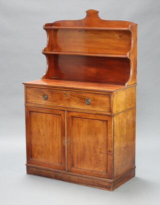 Wilkinsons, a Regency mahogany secretaire chiffonier, the shaped raised back fitted 2 shelves, the chiffonier drawer marked Wilkinsons and stamped 7651, having a fitted interior above 3 long drawers, raised on a platform base 143cm h x 94cm w x 47cm d