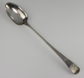 A Georgian style white metal basting spoon with engraved monogram, rubbed marks, 106 grams 