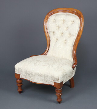 A Victorian mahogany show frame nursing chair upholstered in white buttoned material, on turned supports 89cm h x 53cm w x 58cm d 