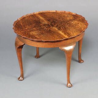 A circular Queen Anne style quarter veneered walnut occasional table with pie crust decoration, raised on cabriole supports 42cm h x 60cm diam. 
