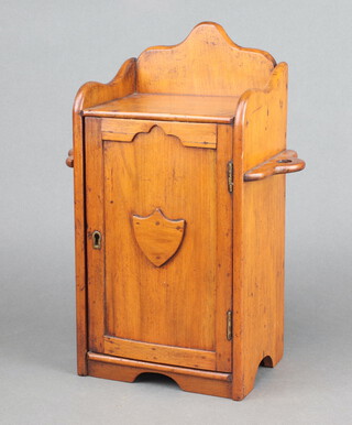 A Victorian mahogany smoker's cabinet with raised back the sides fitted receptacle  holders, the interior fitted a drawer enclosed by a panelled door 34cm h x 33cm x 13cm d 