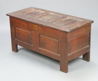 A 17th/18th Century oak coffer of panelled construction and hinged lid, the interior fitted a candle box 52cm h x 109cm x 47cm d 