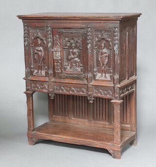 A Victorian carved oak cabinet with moulded cornice enclosed by a panelled door, carved medieval court figures and with linenfold panels to the sides raised on square supports with undertier 130cm h x 109cm w x 48cm d 