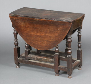 A 17th/18th Century oval oak drop flap gateleg tea table, formerly fitted a drawer, raised on turned supports 68cm h x 85cm w x 33cm d  