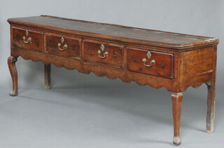 A 17th  Century oak dresser base, the top formed from 3 planks fitted 4 drawers with steel locks, brass escutcheons and replacement swan neck drop handles, raised on cabriole supports 84cm h x 238cm w x 44cm d 