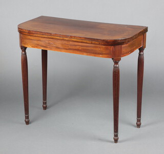 A Georgian inlaid and crossbanded mahogany D shaped card table, raised on turned and reeded supports 72cm h x 84cm w x 43cm d 