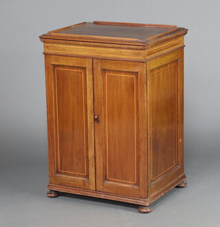 A 19th Century mahogany pedestal free standing cabinet with 3/4 gallery above an interior fitted shelves enclosed by panelled door with later brown Bakelite handle, raised on bun supports 86cm h x 60cm w x 49cm d  