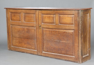 An 18th/19th Century bleached oak cabinet with shelved interior enclosed by panelled doors 101cm h x 203cm w x 38cm d 