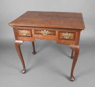 An 18th Century oak side table, the top formed of 3 planks with dentil cornice to the front, fitted 1 long and 2 short crossbanded drawers, raised on cabriole supports 73cm h x 78cm w x 54cm d 