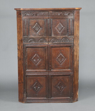 An oak corner cabinet, the front formed from old timbers removed from coffers marked 1651 150cm h x 109cm w x 75cm d 