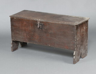 A late 16th early 17th Century oak coffer constructed of 6 planks with long iron hinges and iron lock plate, the interior fitted a candle box 52cm h x 103cm w x 34cm d 