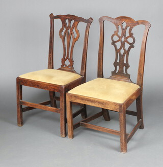 A near pair of 19th Century mahogany Chippendale style slat back dining chairs with pierced vase shaped backs and upholstered drop in seats, raised on square tapered supports 95cm h x 52cm w x 43cm 