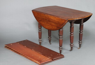 A 19th Century Continental drop flap mahogany dining table, raised on 6 turned and reeded supports, brass caps and ceramic casters together with 4 extra leaves 70cm h x 114cm w x 58cm l when closed x 167cm when extended  