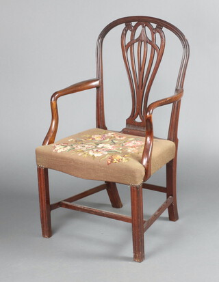 A Georgian Hepplewhite style open arm carver chair with vase shaped slat back and overstuffed seat upholstered in Berlin woolwork, raised on square chamfered supports 99cm h x 57cm w x 45cm d 