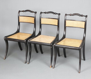 A set of 3 Regency ebonised rope back dining chairs with woven cane seats and backs, raised on sabre supports 82cm h x 45cm w x 41cm d 