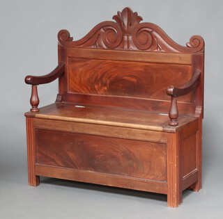 An Edwardian carved walnut settle, the seat with hinged lid 109cm h x 111cm w x 42cm d (seat 68cm x 34cm) 