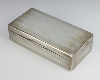 A rectangular silver engine turned cigarette box London 1919 18cm 