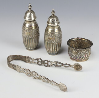 A pair of Victorian repousse silver peppers Birmingham 1890, a mustard and a pair of sugar nips 123 grams 