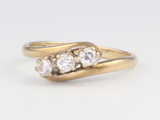 A 9ct yellow gold 3 stone diamond crossover ring, approx. 0.25ct, size J 1/2, 2.1 grams