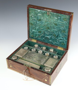 A mid Victorian brass bound rosewood toilet box with fitted interior, the drop flap revealing a mirror and having 3 silver mounted cut glass jars, London 1851, circular silver box and cover London 1814, 3 mounted scents with plated lids, 5 cut glass bottles, the lid having an engraved monogram cartouche 