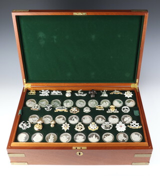 A set of 52 proof finish silver medallions, commemorating The Great British Regiments by The Birmingham Mint, each approx. 45 grams together with 52 reproduction British Regimental cap badges, contained in a brass mounted mahogany chest with 2 fitted drawers and original paperwork, no. 252 of 3000, total weight 2340 grams 