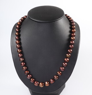 A string of ochre coloured cultured pearls with a 2 colour 375 clasp 54cm 