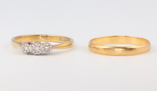 An 18ct yellow gold illusion set 3 stone diamond ring, approx 0.05ct, size N, 2.3 grams, together with a 22ct yellow gold wedding band 1.7 grams size N  
