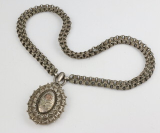 A Victorian silver locket Birmingham 1885 on a white metal necklace