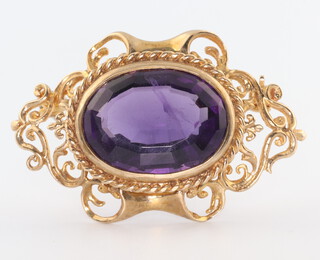 A 9ct yellow gold amethyst Victorian style scroll brooch 10.2 grams, 35mm