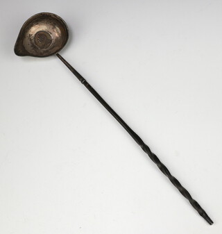 A Georgian white metal punch ladle with whale bone handle and coin set base 1736 